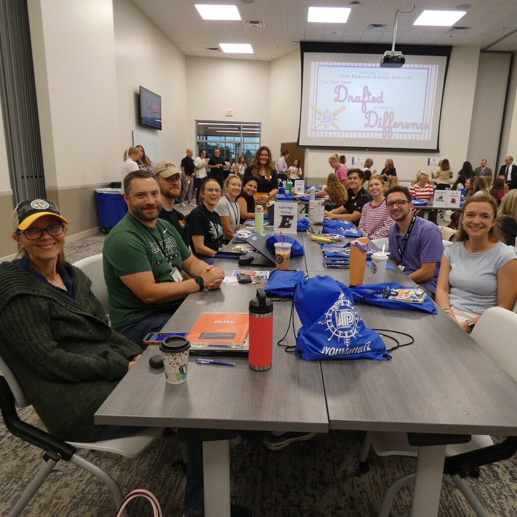 New teachers flank table as work begins