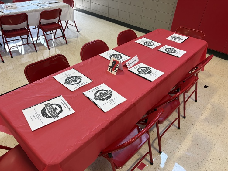 Red tablecloth in a table with handbooks