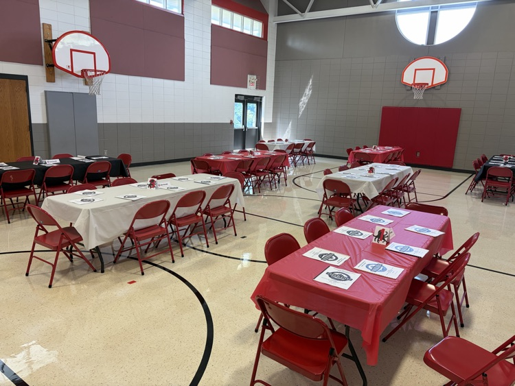 red and black and white table cloths on a bunch of tables