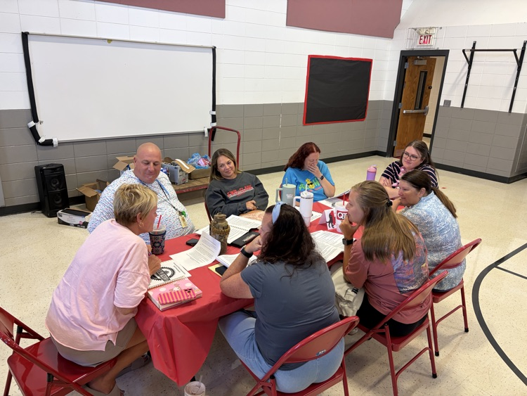 adults sitting around a table chatting