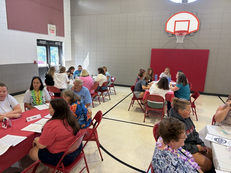 adults sitting around a table chatting