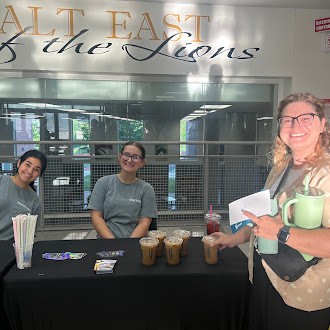 Teacher smiles picking up free coffee