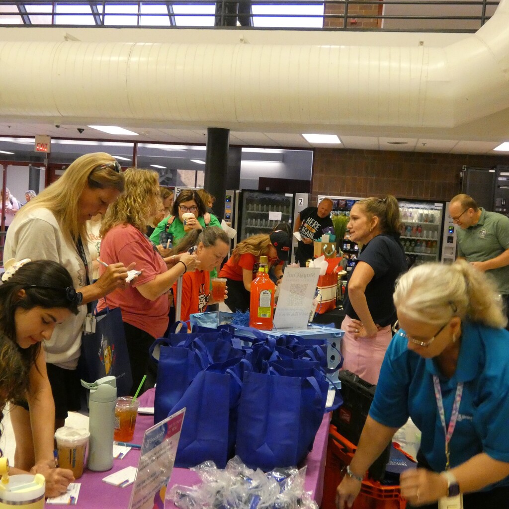 Teachers fill out raffle tickets with businesses