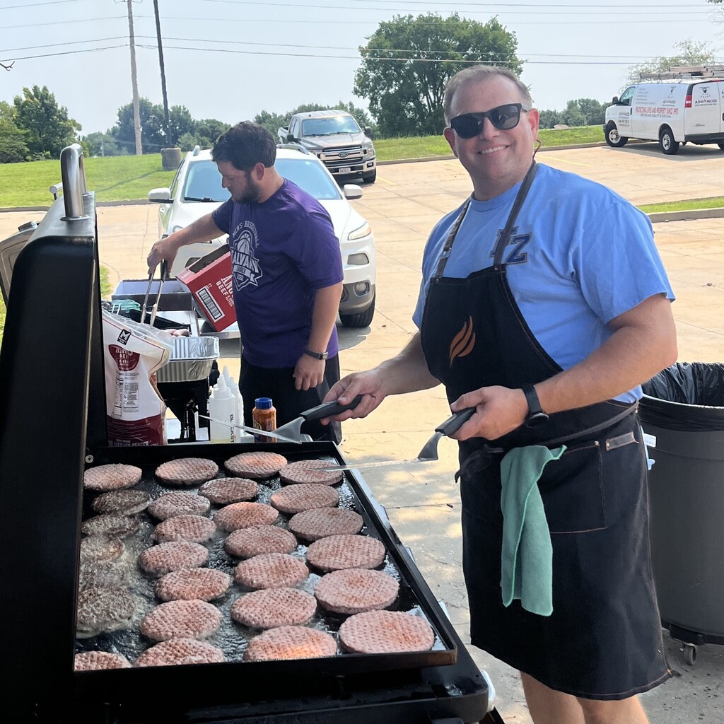 administrators work the grill