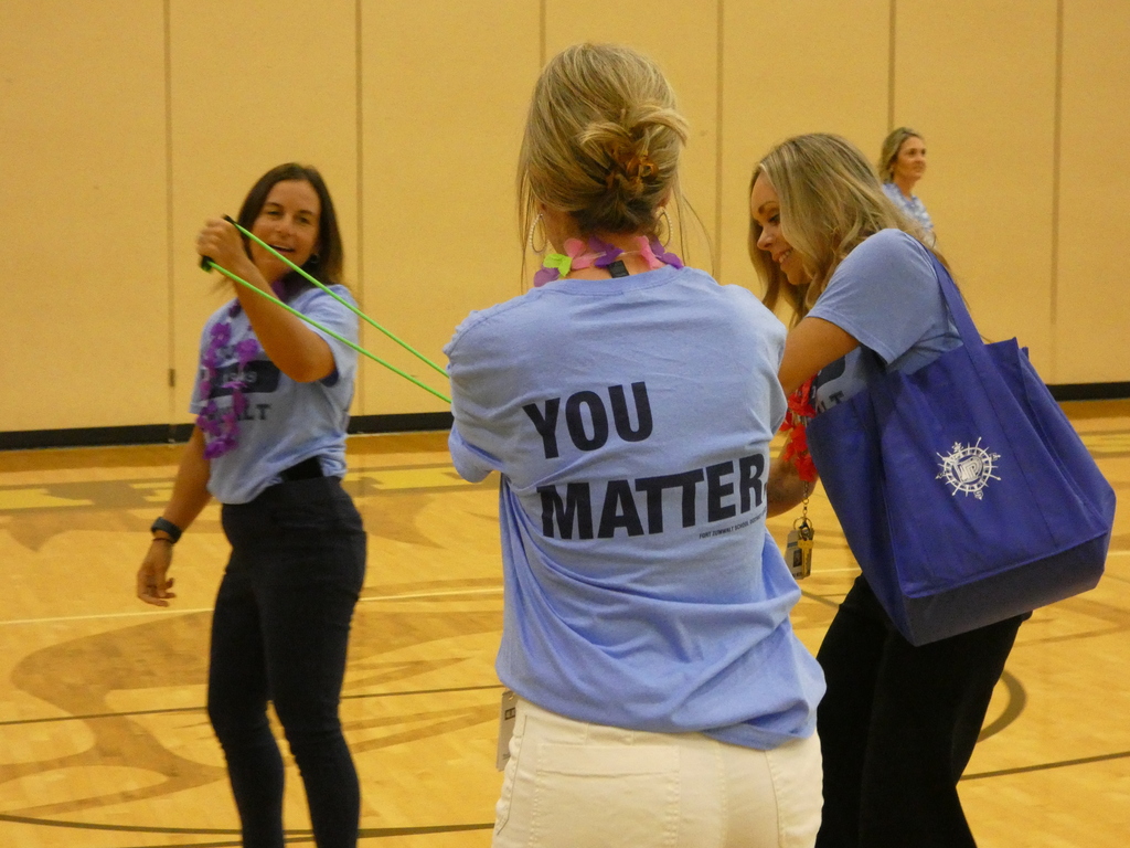 Employees sling t-shirts into the crowd.