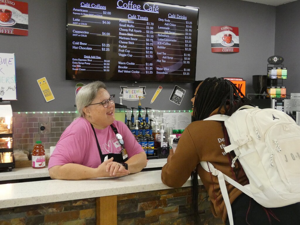 coffee bar clerk visits with student