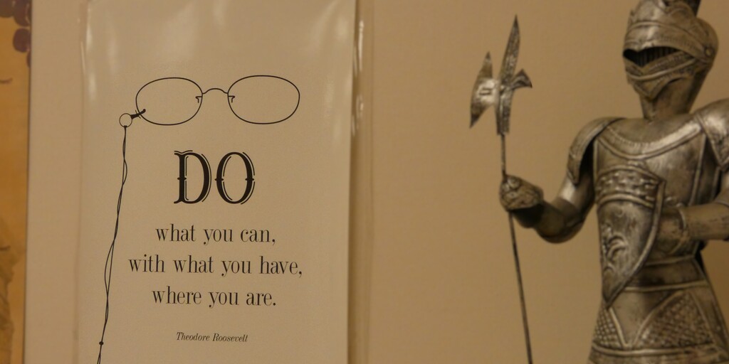 A knight guards a poster with an inspirational quote