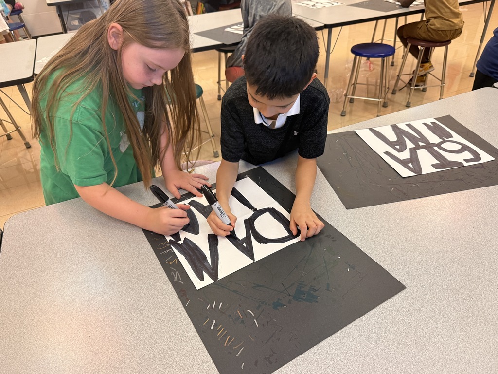 2 students working on art project
