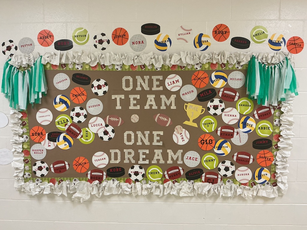 Bulletin board with sports equipment cut outs and words that day one team, one dream.