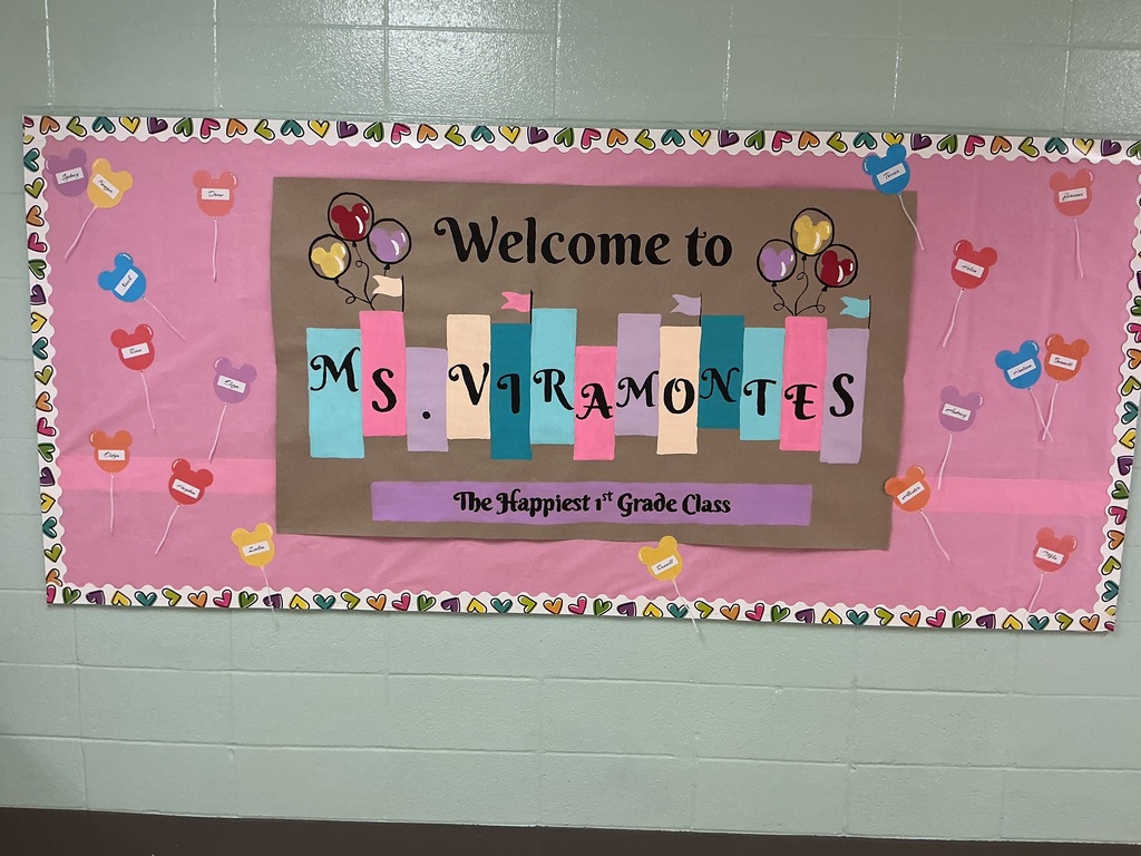 A bulletin board that says Welcome to Ms. Viramontes The Happiest 1st Grade Class.
