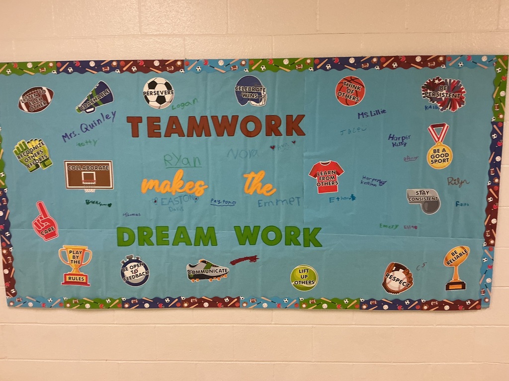 A bulletin board that says teamwork makes the dream work with sports items surrounding it.