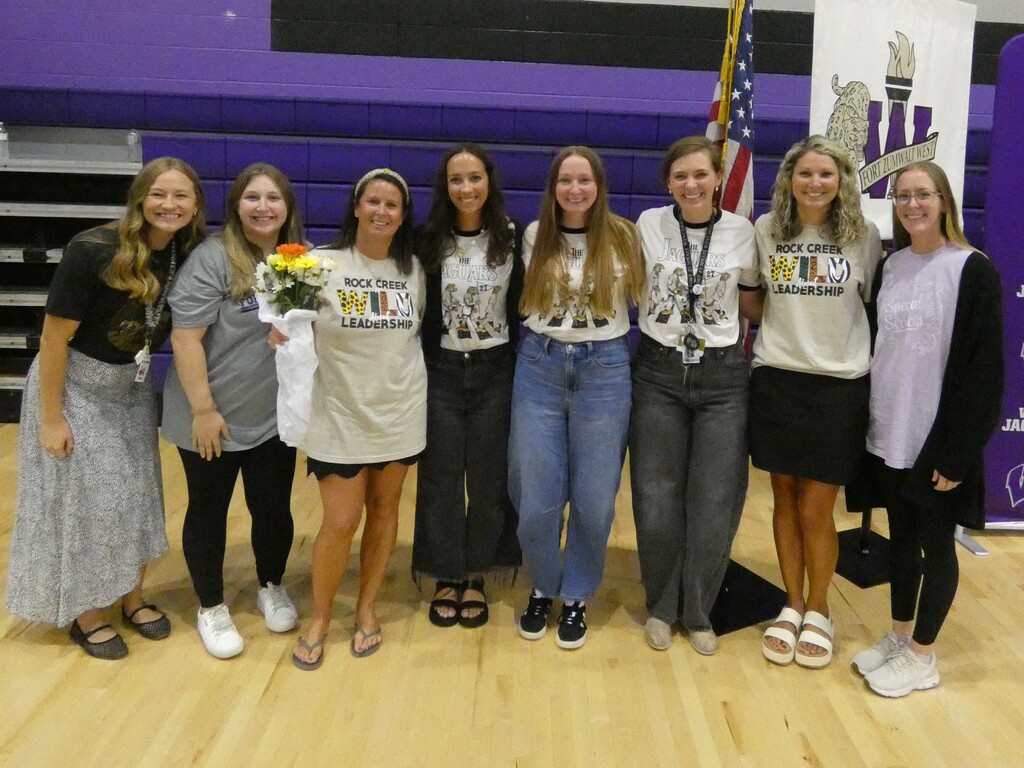Veteran teachers pose with GYO para who is holding flowers