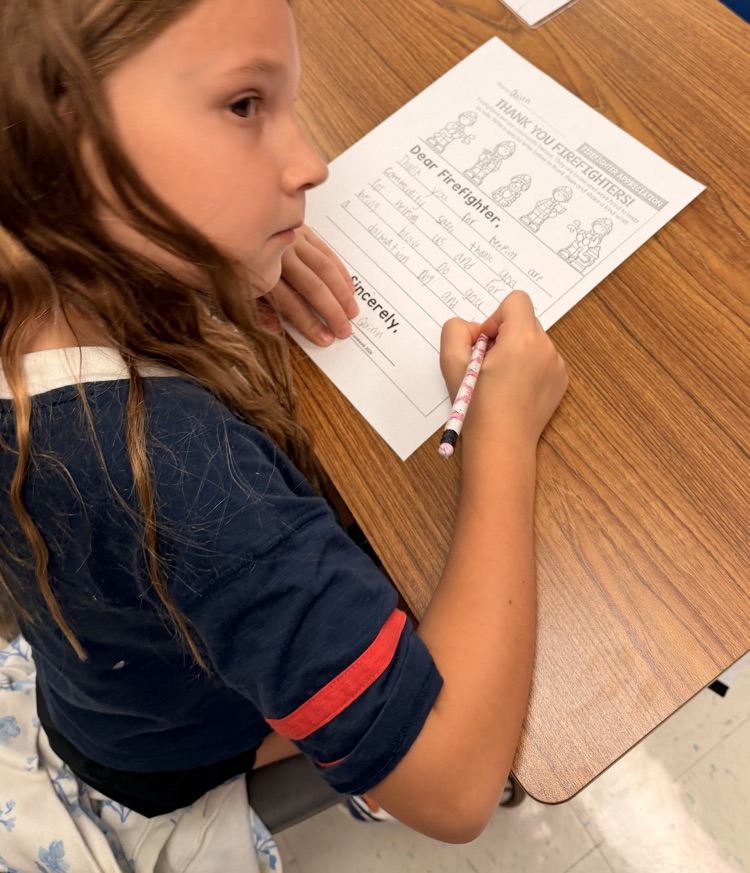 student writing about firemen 