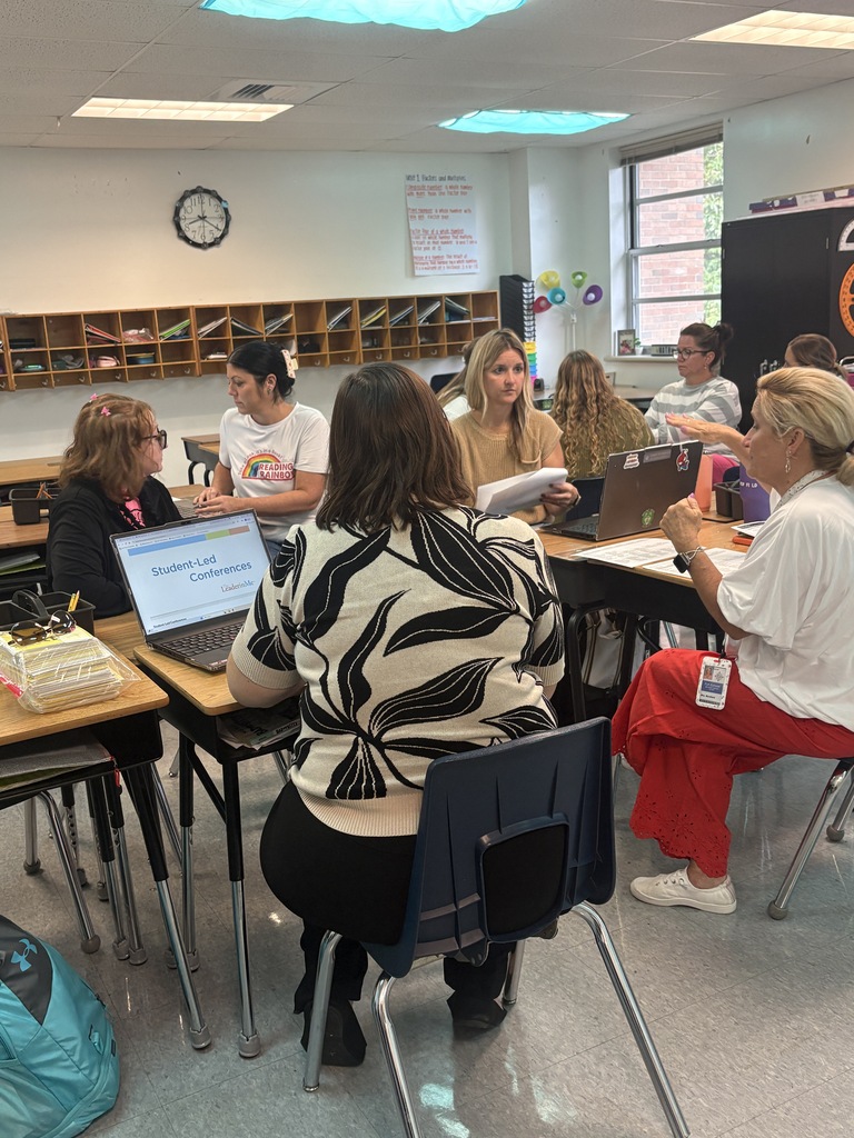 Teachers speaking to their students about a fundraiser for the school.
