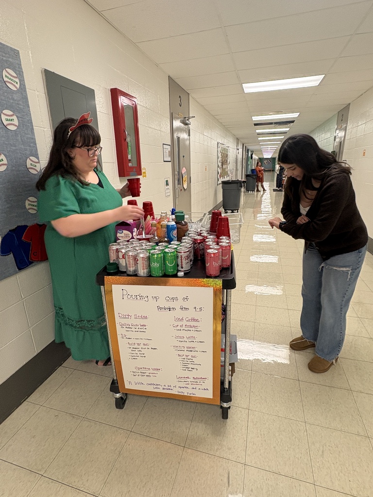 Teachers drinking coffee and soda out of red cups.