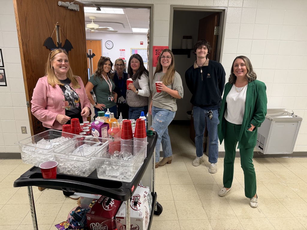 Teachers drinking coffee and soda out of red cups.