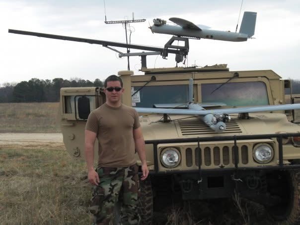 Greg Kaelin posing in front of a Hummer with a drone on top.