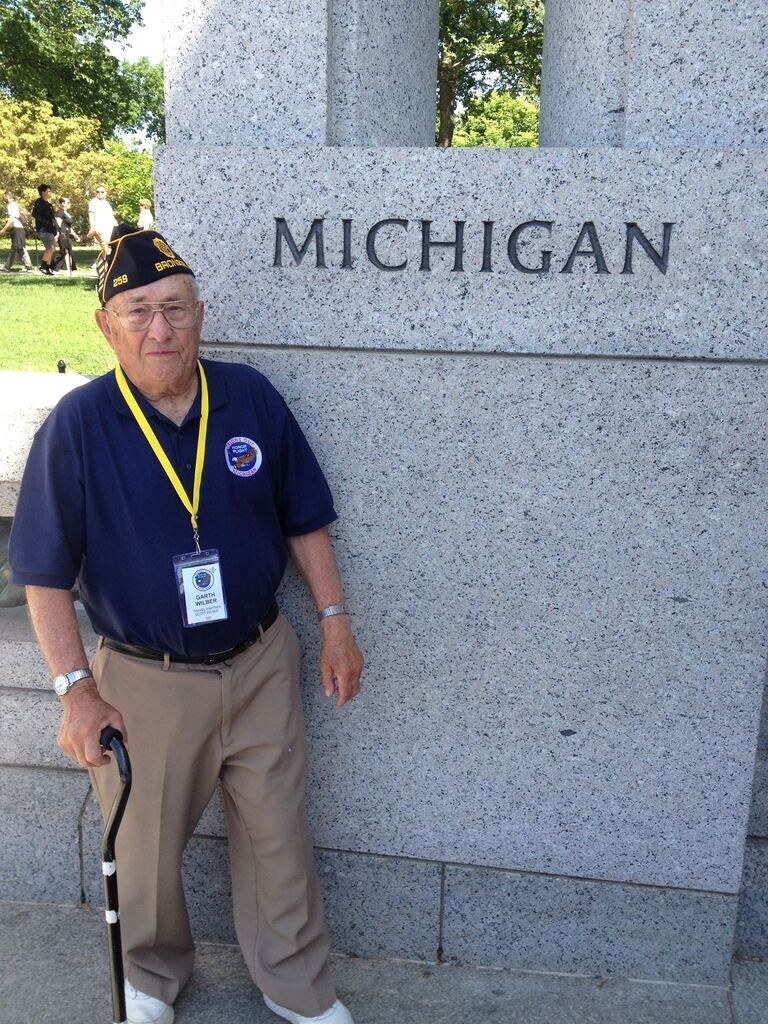 Garth Wilber next to a war monumnet in Michigan