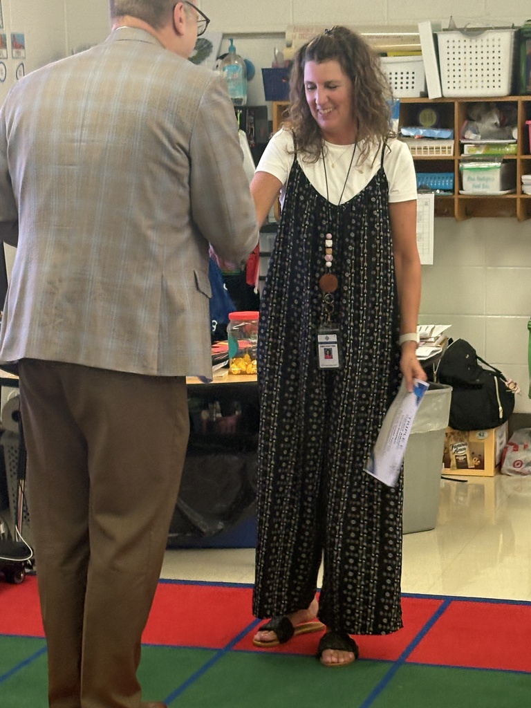 A man shaking hands with a teacher.