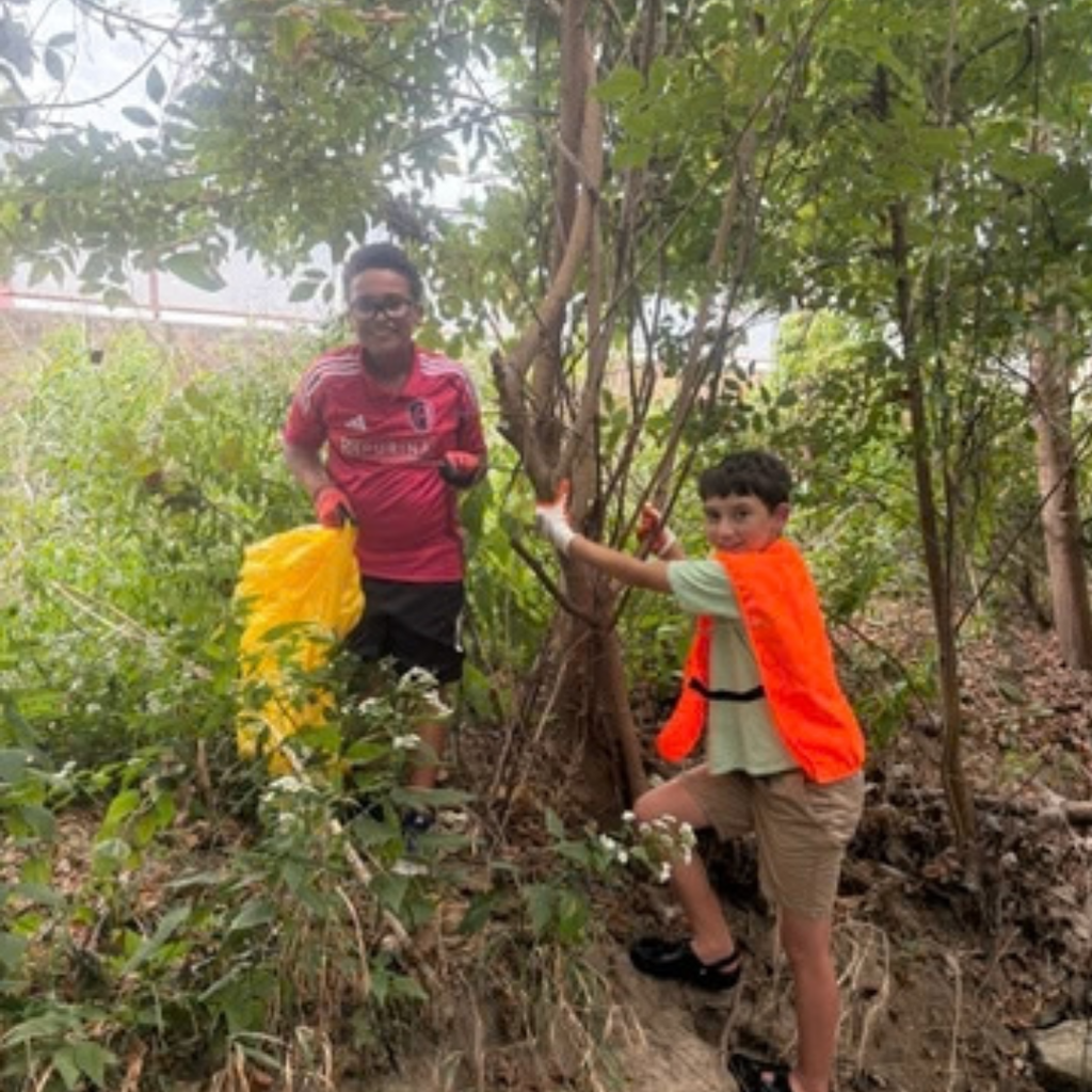 students cleaning creek after school