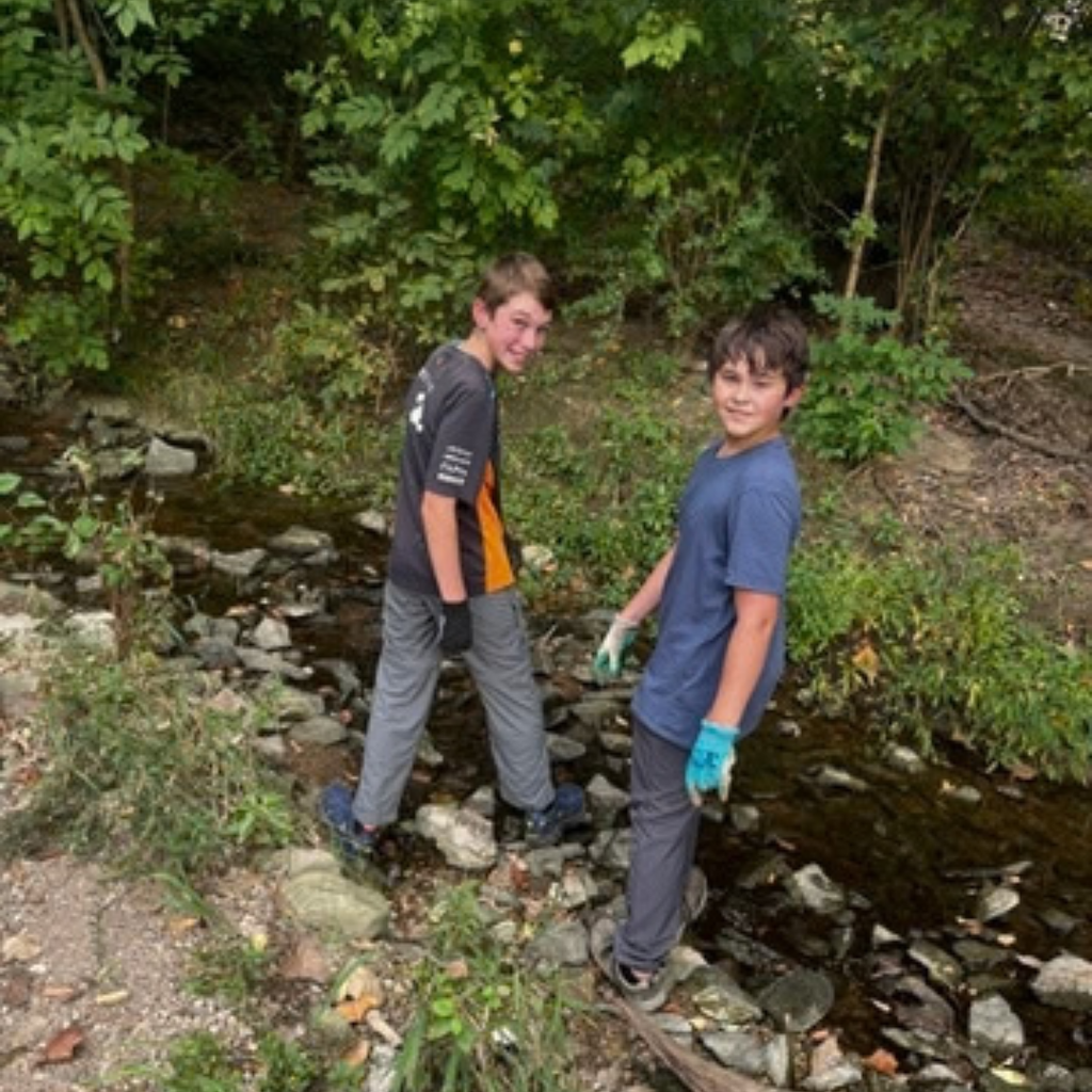 students cleaning creek after school