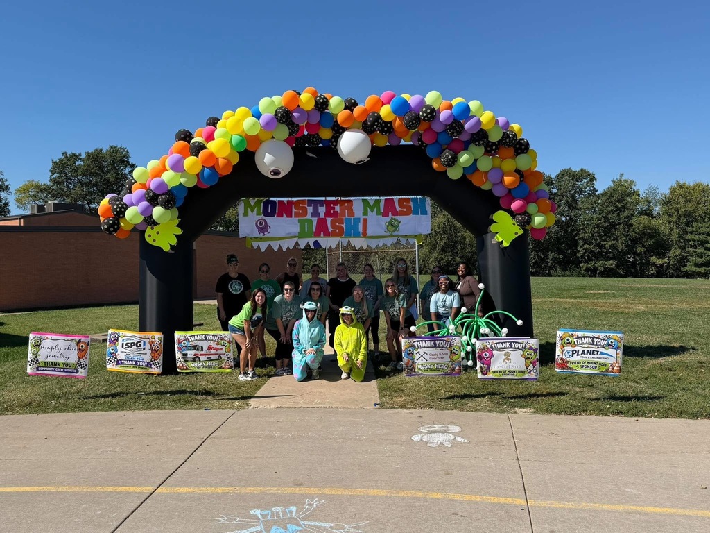 Teachers and students preparing to start a fun run.