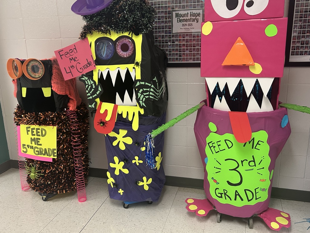 Fund raising buckets for each grade level decorated as monsters.
