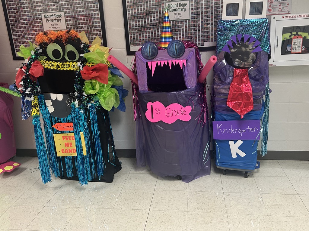 Fund raising buckets for each grade level decorated as monsters.