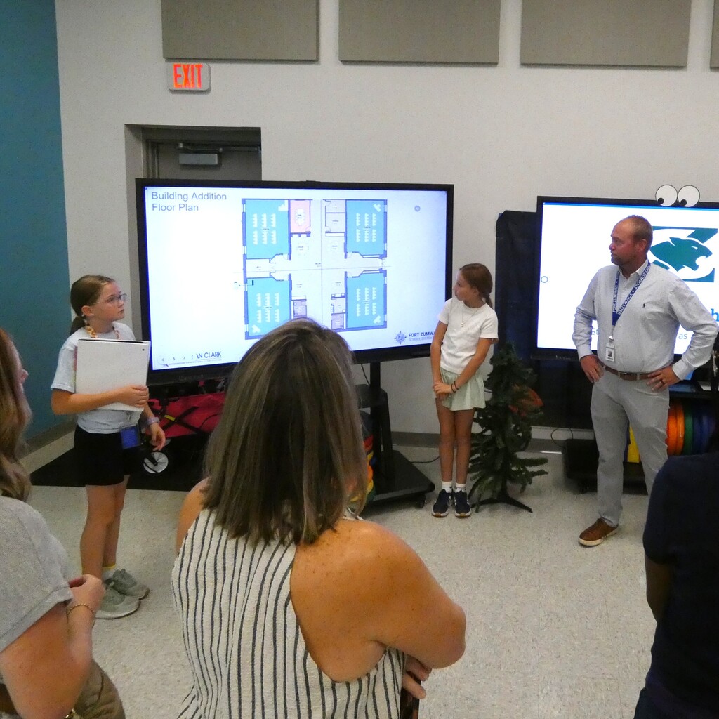 Construction Manager stands by for questions as students present blueprint