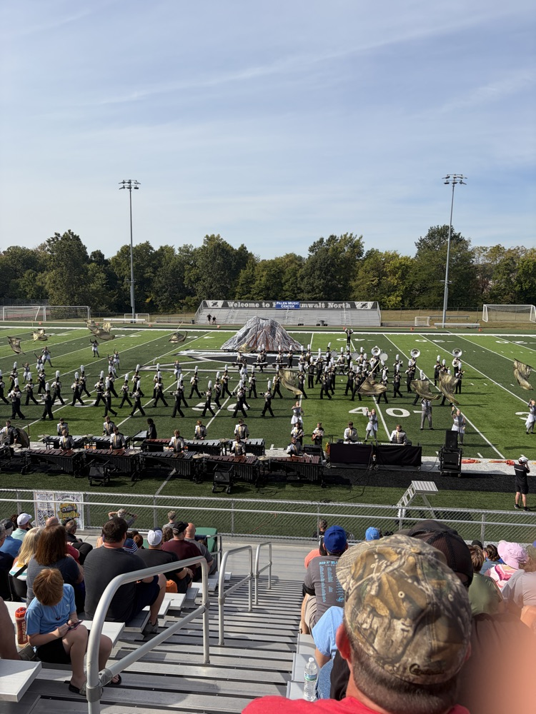 The full Lion Pride band with color guard throwing their flags