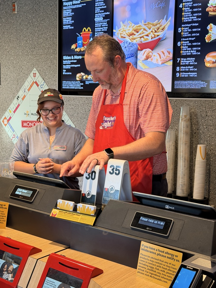 Mr Johnson standing at a cash register!