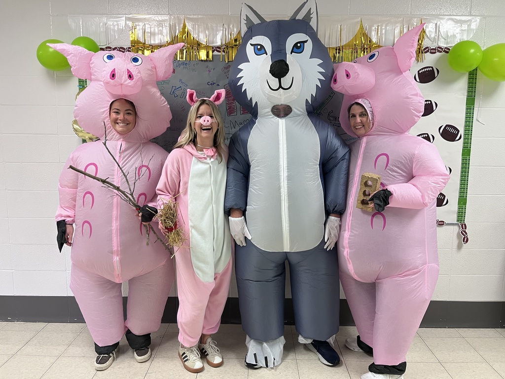 Teachers dressed up as the three little pigs and the big bad wolf.