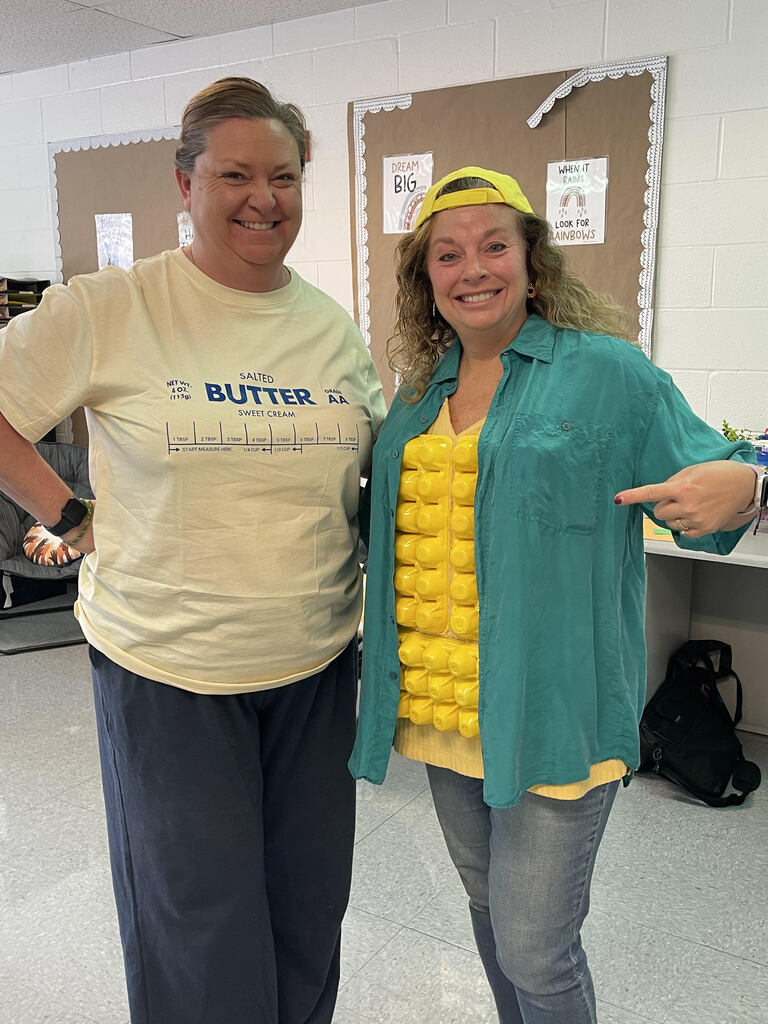 One teacher dressed up as corn and the other dressed up as butter.