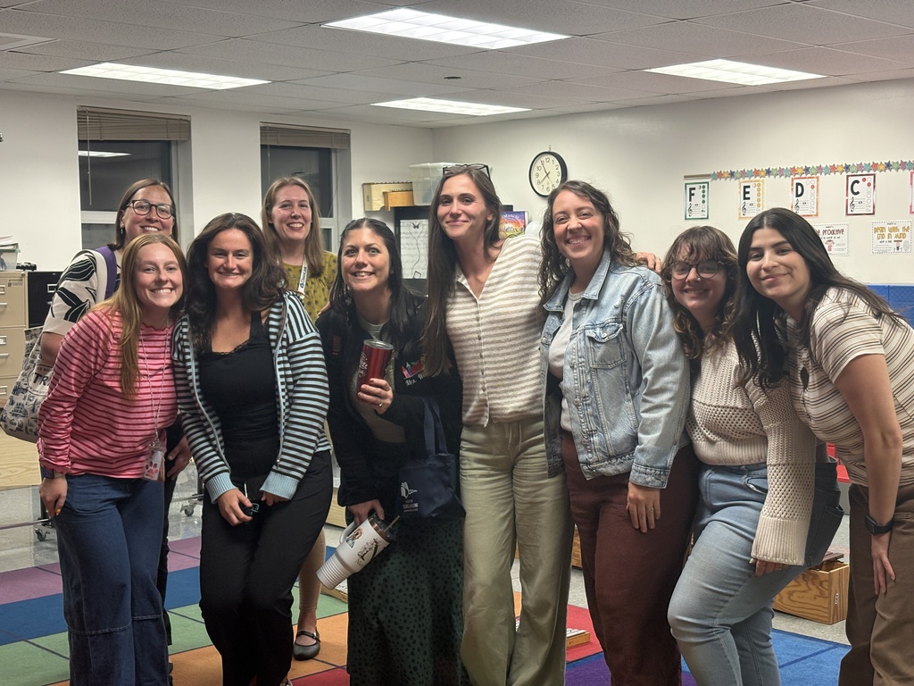 A group of teachers smiling together after conferences