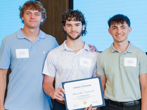 students pose with award