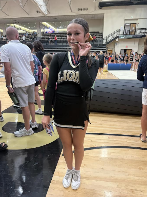 Caroline Musgrove biting her all american medal