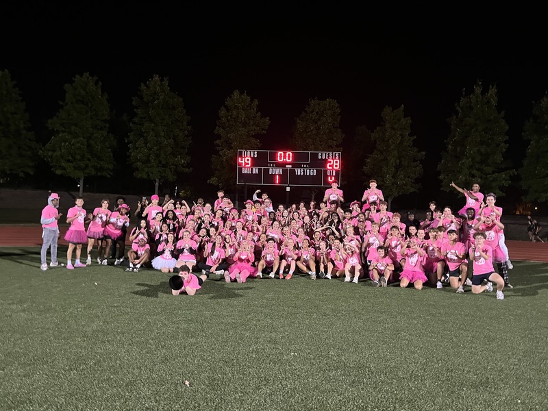 Seniors posing under the scoreboard