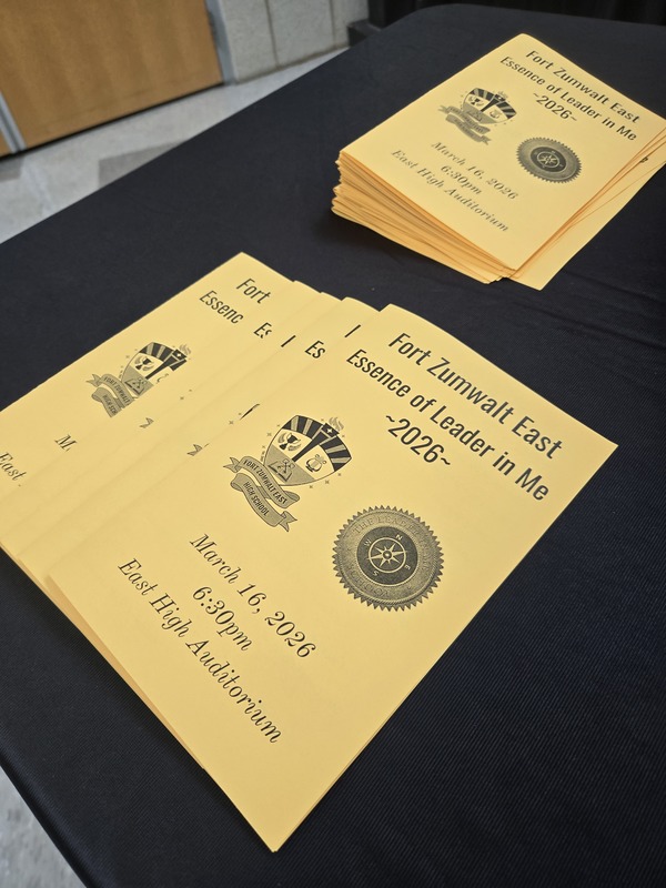 Gold programs laying on a table