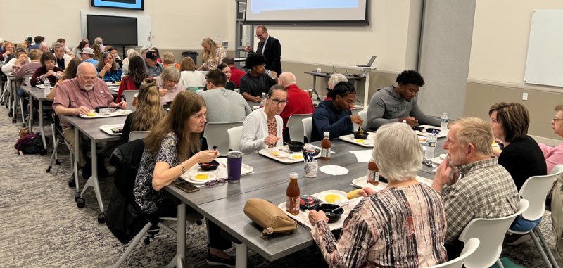 The crowd visits over lunch as the Superintendent mingles