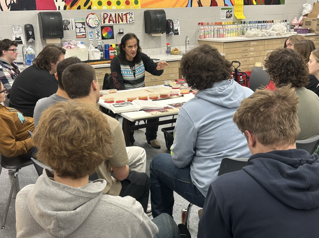 Dennis Rogers teaches about "Native American sand art" & flute  (at Fosston high school).