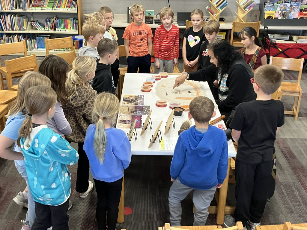 Dennis Rogers teaches about "Native American sand art" & flute  (at Fosston elementary school).