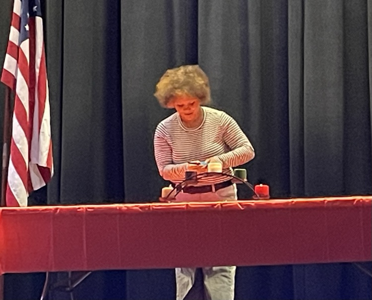 Iyzella lights the purple candle representing character.