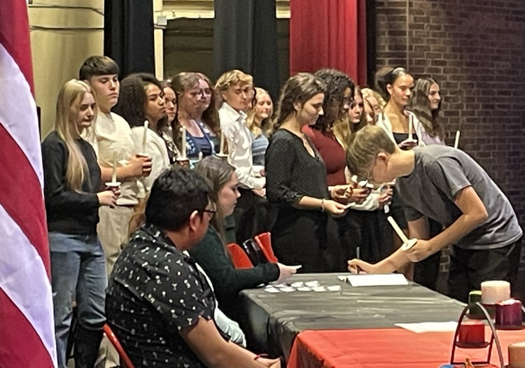 New members signed the official register and received their membership cards, both lasting records of their achievement.