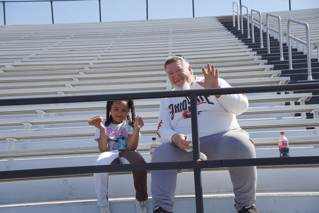 Bus driver with granddaughter watching track