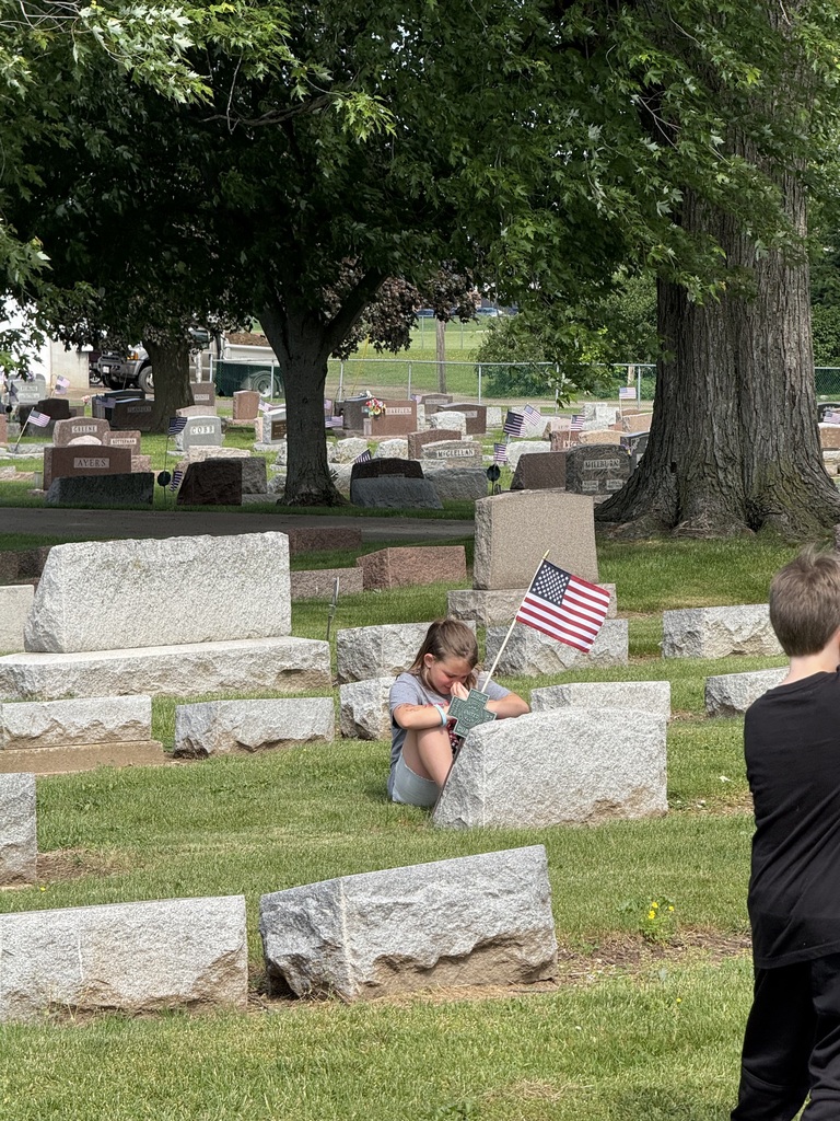 students saying "thank you" as they plant flags for Memorial Day