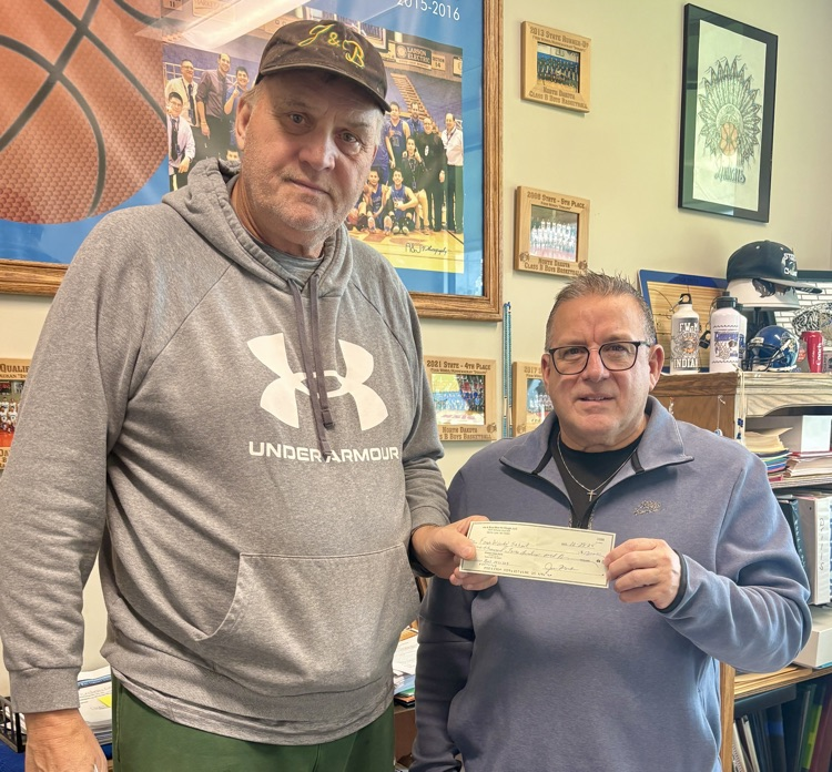 Joe Mertens from Joe and Bros Mow For Dough presenting check to Rick Smith for electronic down market for football field