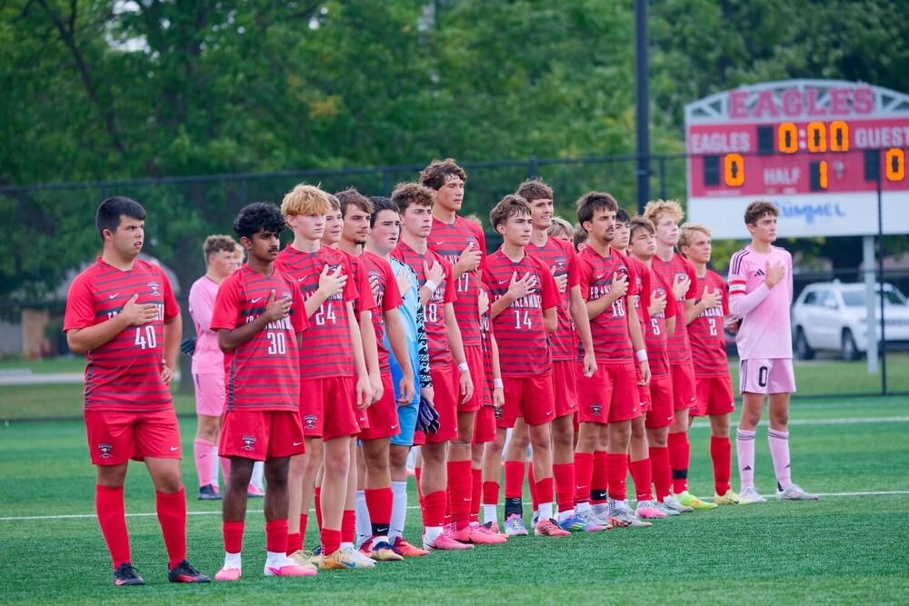 soccer team lines up for national anthem