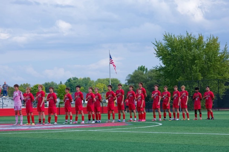 Frankenmuth Varsity Soccer Team lines us for the national anthem at their first home game