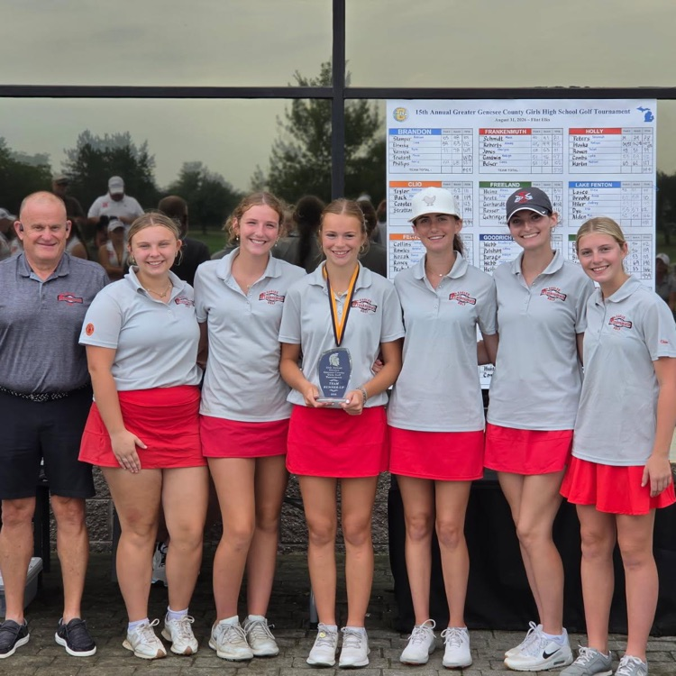 girls golf team poses with trophy