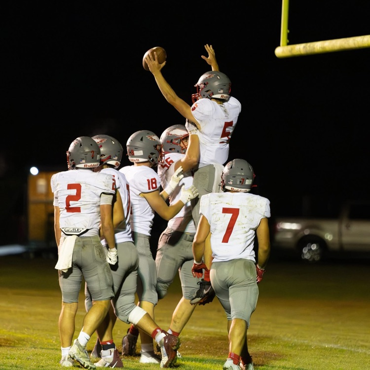 football players celebrate in end zone 